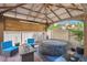 Relaxing backyard patio with a covered pergola, hot tub, and comfortable seating area at 4992 W Moberly Ave, Las Vegas, NV 89139