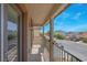 Balcony with decorative pillars and metal railing overlooking street at 4992 W Moberly Ave, Las Vegas, NV 89139