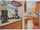 Custom bar area featuring custom glass shelves, countertops and modern appliances at 4992 W Moberly Ave, Las Vegas, NV 89139