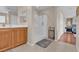 Bright bathroom with a glass enclosed shower and warm wood vanity at 4992 W Moberly Ave, Las Vegas, NV 89139