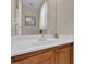 Bathroom featuring a sink and vanity with white countertop and wooden cabinets at 4992 W Moberly Ave, Las Vegas, NV 89139