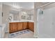 Bathroom with a double sink, a glass enclosed shower and a soaking tub at 4992 W Moberly Ave, Las Vegas, NV 89139