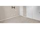 Empty bedroom with neutral walls, carpeted floors, and white doors at 4992 W Moberly Ave, Las Vegas, NV 89139
