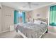 Cozy bedroom showcasing neutral walls, plush carpet, and bright windows with blue curtains at 4992 W Moberly Ave, Las Vegas, NV 89139
