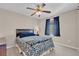 Bedroom featuring floral bedding, ceiling fan and carpeted floors at 4992 W Moberly Ave, Las Vegas, NV 89139