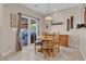 Cozy dining area with table and chairs, sliding door access to the back patio and hot tub at 4992 W Moberly Ave, Las Vegas, NV 89139