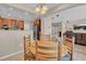 Open-concept dining area with views into the kitchen and living room with staircase at 4992 W Moberly Ave, Las Vegas, NV 89139