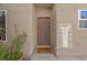 Home's front door has security features and is surrounded by a stucco wall and trim at 4992 W Moberly Ave, Las Vegas, NV 89139