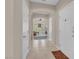Bright entrance hallway featuring neutral walls and trim, ceramic tile and open archway to living spaces at 4992 W Moberly Ave, Las Vegas, NV 89139