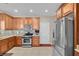Functional kitchen featuring stainless steel appliances, wooden cabinetry, and an efficient layout at 4992 W Moberly Ave, Las Vegas, NV 89139