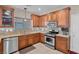 Well-designed kitchen featuring stylish tile backsplash, stainless steel appliances and plenty of cabinets at 4992 W Moberly Ave, Las Vegas, NV 89139