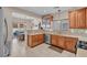 Bright kitchen with wooden cabinets, stainless steel appliances, and dining area in view at 4992 W Moberly Ave, Las Vegas, NV 89139