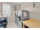 Functional laundry room with stacked washer and dryer and added storage space at 4992 W Moberly Ave, Las Vegas, NV 89139