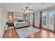 Comfortable main bedroom with a ceiling fan and a private balcony entrance at 4992 W Moberly Ave, Las Vegas, NV 89139