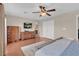 Main bedroom featuring wood floors, a television, and dresser for ample storage at 4992 W Moberly Ave, Las Vegas, NV 89139