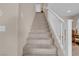 Carpeted staircase with white railing leading to the upper level of the home at 4992 W Moberly Ave, Las Vegas, NV 89139