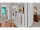 Upstairs hallway with wood floors, a laundry area, and access to bedrooms at 4992 W Moberly Ave, Las Vegas, NV 89139