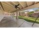 This covered back patio has a ceiling fan and an extended patio area with a grassy area at 51 La Fiesta St, Henderson, NV 89012