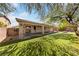 This backyard features a swing and covered patio with a grassy area at 51 La Fiesta St, Henderson, NV 89012