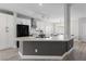 Modern kitchen featuring white cabinets, black appliances, and a large center island with quartz countertops at 51 La Fiesta St, Henderson, NV 89012