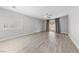 Large living room with light wood floors, plantation shutters, and sliding glass doors to the backyard at 51 La Fiesta St, Henderson, NV 89012