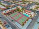 Aerial view featuring tennis courts and a pool surrounded by tropical palm trees in a residential complex at 5185 Indian River Dr # 229, Las Vegas, NV 89103