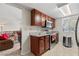 Well-equipped kitchen with granite countertops and stainless steel appliances, adjacent to a cozy living area at 5185 Indian River Dr # 229, Las Vegas, NV 89103