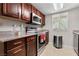 Cozy kitchen with dark wood cabinets, stainless steel appliances, and granite countertops at 5185 Indian River Dr # 229, Las Vegas, NV 89103