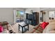 Open-concept living room features a slider to a balcony, neutral decor, and dark wood entertainment center at 5185 Indian River Dr # 229, Las Vegas, NV 89103