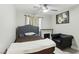 Well-lit bedroom with a ceiling fan, a fireplace, and a sitting chair at 5220 Remini Ct, Las Vegas, NV 89130