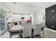 Open dining area with hardwood floors, modern chandelier, and easy access to the kitchen at 5220 Remini Ct, Las Vegas, NV 89130