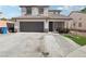 Charming two-story home featuring a two-car garage, well-maintained landscaping, and a welcoming entrance at 5220 Remini Ct, Las Vegas, NV 89130
