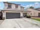 Lovely two-story home with a two-car garage, manicured lawn, and inviting front porch at 5220 Remini Ct, Las Vegas, NV 89130