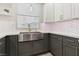 Kitchen featuring a stainless steel sink and a modern gray and white color scheme at 5220 Remini Ct, Las Vegas, NV 89130