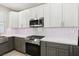 Modern kitchen featuring white and gray cabinets and stainless steel appliances at 5220 Remini Ct, Las Vegas, NV 89130