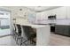 Modern kitchen with quartz counters, gray cabinets and stainless steel appliances at 5220 Remini Ct, Las Vegas, NV 89130