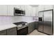 Contemporary kitchen with stainless steel appliances and modern gray and white cabinets at 5220 Remini Ct, Las Vegas, NV 89130