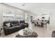Bright, open-concept living area with hardwood floors, plush seating, and lots of natural light at 5220 Remini Ct, Las Vegas, NV 89130