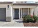 Inviting front porch with a 'Welcome' sign, cozy seating, and colorful floral accents at 5220 Remini Ct, Las Vegas, NV 89130