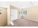 A neutral-toned bedroom has a window view, closet, and carpet flooring at 5329 La Patera Ln, Las Vegas, NV 89149