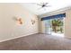 Bedroom with balcony access featuring a ceiling fan and sconce lighting at 5329 La Patera Ln, Las Vegas, NV 89149