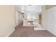 Upstairs hallway with carpet and railing overlooking the lower level living spaces at 5329 La Patera Ln, Las Vegas, NV 89149