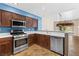 Bright and open kitchen features stainless steel appliances and a breakfast bar at 5329 La Patera Ln, Las Vegas, NV 89149