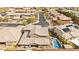 Aerial view of a home with a pool, spa, and solar panels in a neighborhood at 5523 Kyle Peak Ct, Las Vegas, NV 89135