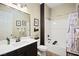 Bathroom featuring a vanity with ample storage, a toilet, and a shower-tub combination, all stylishly designed at 5523 Kyle Peak Ct, Las Vegas, NV 89135