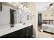 Bathroom featuring double sinks with black cabinets and a bedroom view at 5523 Kyle Peak Ct, Las Vegas, NV 89135
