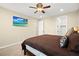 Cozy bedroom featuring a ceiling fan, a TV, and soft carpeting, perfect for relaxation and rest at 5523 Kyle Peak Ct, Las Vegas, NV 89135