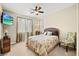 Cozy bedroom with neutral tones, a ceiling fan, and a mounted TV at 5523 Kyle Peak Ct, Las Vegas, NV 89135