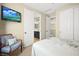 Comfortable bedroom featuring ensuite bathroom, TV, and closet at 5523 Kyle Peak Ct, Las Vegas, NV 89135