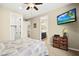 Guest bedroom with TV, wicker cabinet, and adjoining bathroom at 5523 Kyle Peak Ct, Las Vegas, NV 89135